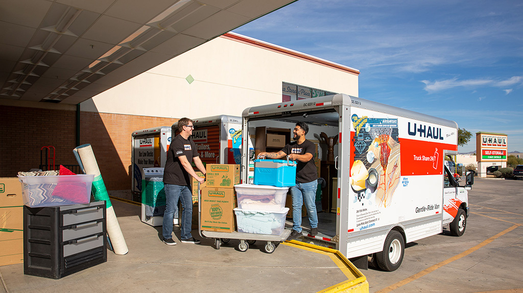 Two Moving Help Service Providers help load a customer’s belongings into a U-Haul truck.