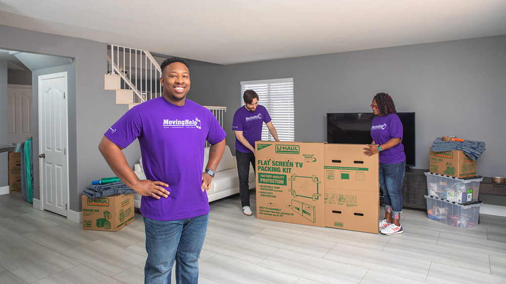 Moving Helpers pose while prepping a customer's belongings.