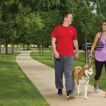 A couple walks with their dog as they prepare for their future PCS move with their pet.