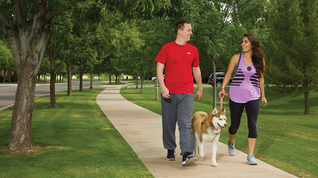 A couple walks with their dog as they prepare for their future PCS move with their pet.