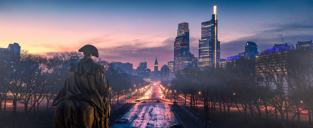 The Washington Monument Fountain located in Eakins Oval can be seen looking toward the parkway on this foggy sunrise in Philadelphia.