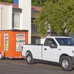 Two Moving Helpers bring a U-Box container to a customer’s home to help her load or unload her belongings. Afterward, they'll bring the container back to the U-Haul location.