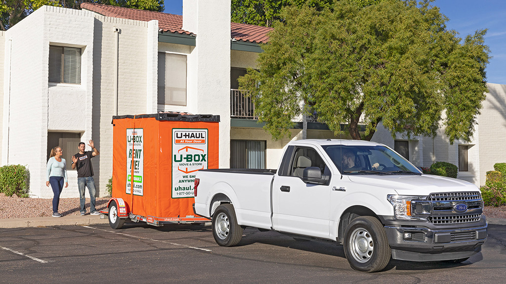 Two Moving Helpers bring a U-Box container to a customer’s home to help her load or unload her belongings. Afterward, they'll bring the container back to the U-Haul location.
