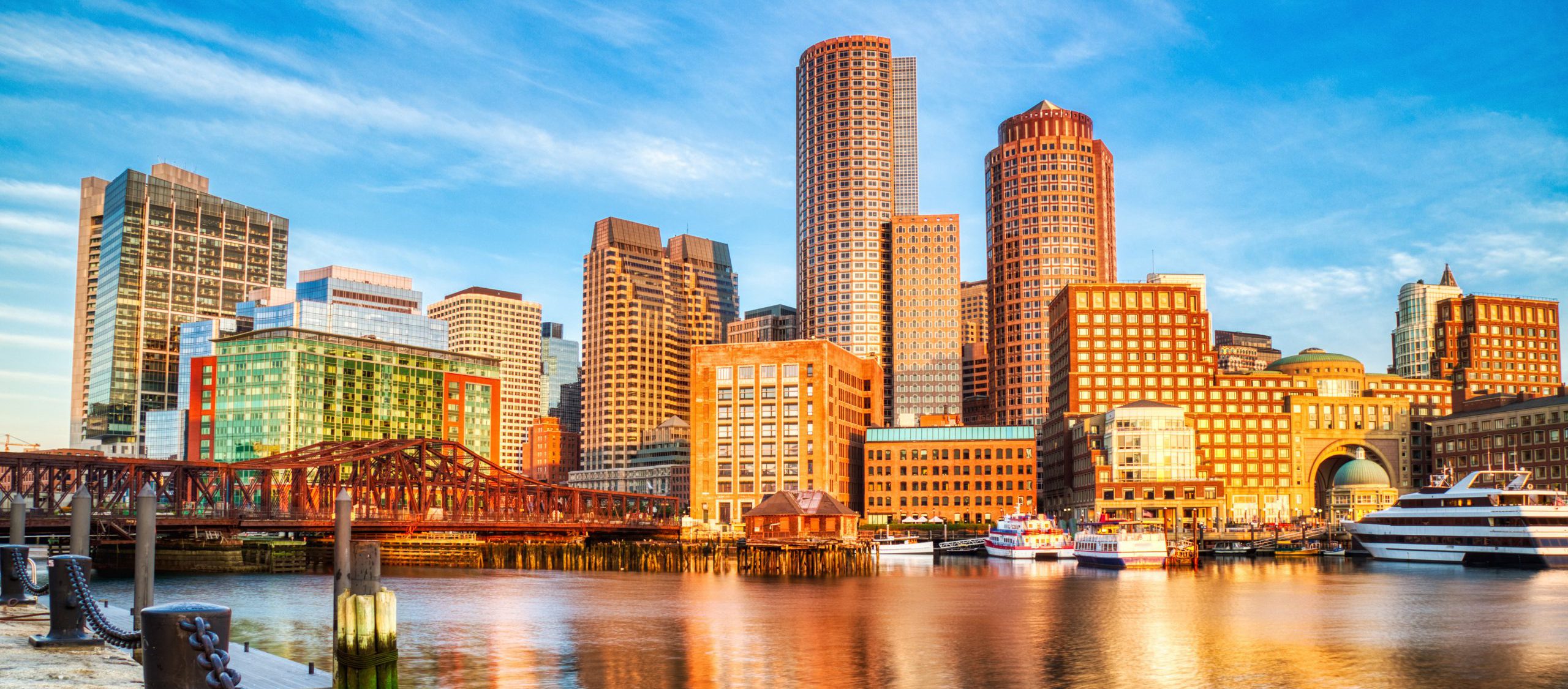 The financial district of Boston reflects on the Boston Harbor.