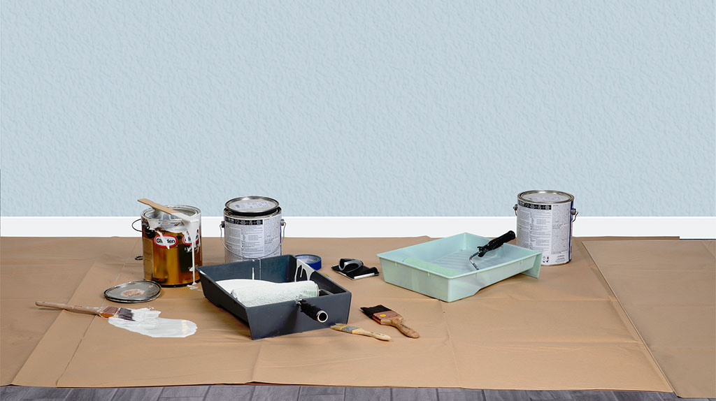 Paint sits on the on the top of paint masking paper with paint brushes. When you leave your home, you can patch up paint spots in your home. It could help you get your security deposit back.