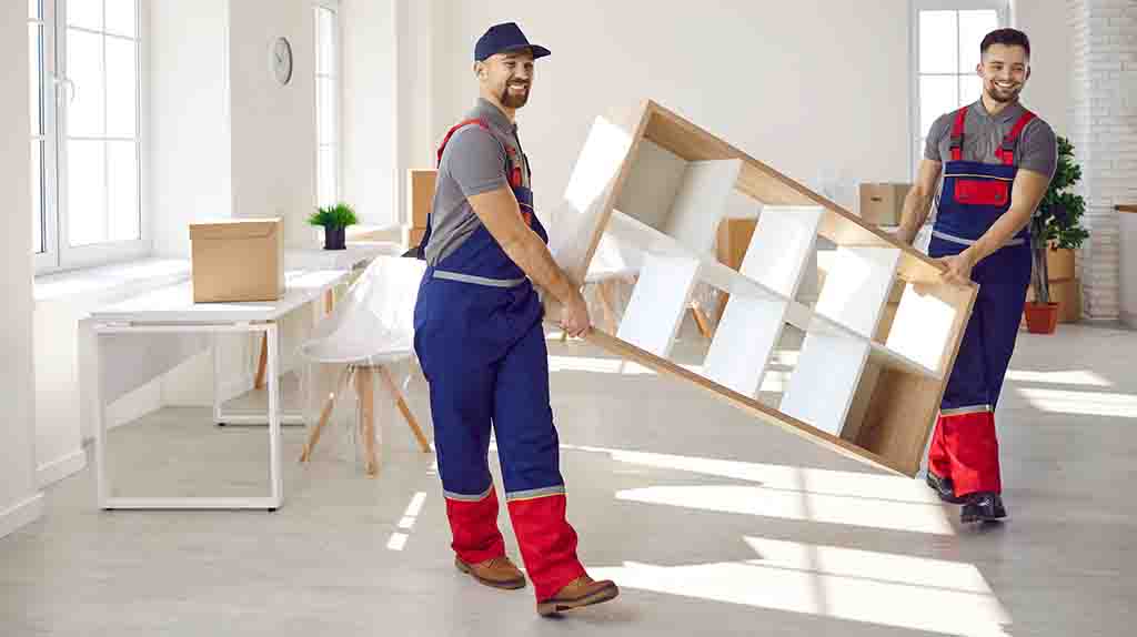 Two Service Providers hold a shelf while walking to the door to load it in a truck. You can reduce moving costs by paying for labor-only providers.