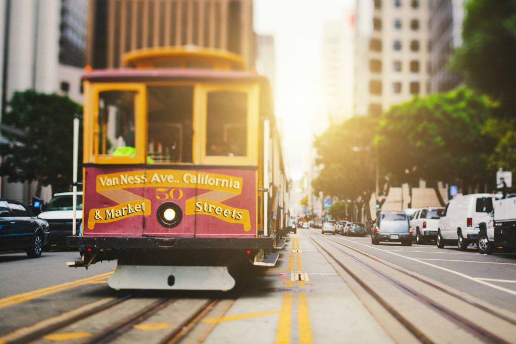 A cable car strolls down the road in downtown San Francisco.