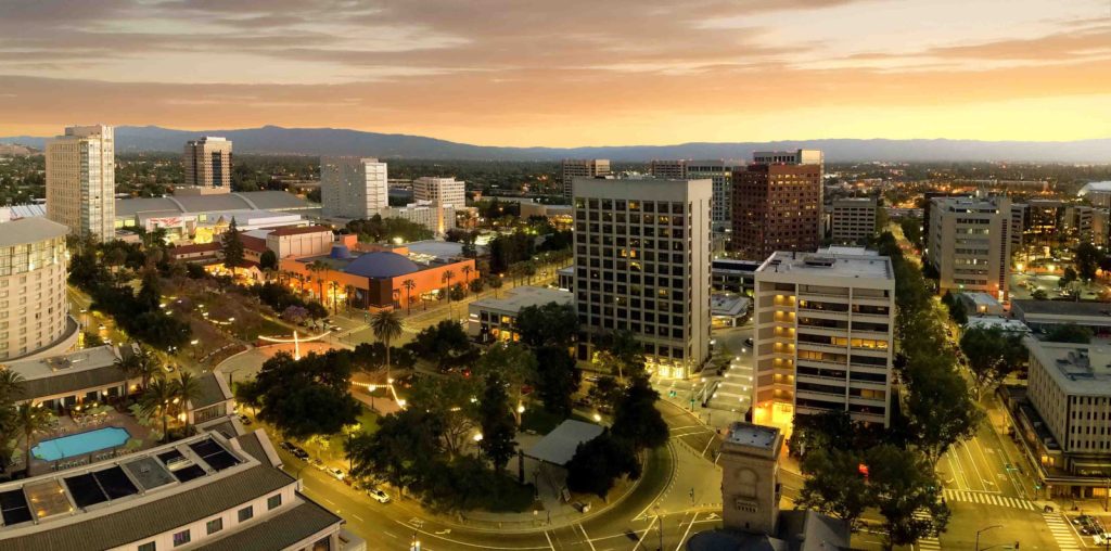 The downtown area in San Jose can be seen during a sunset.