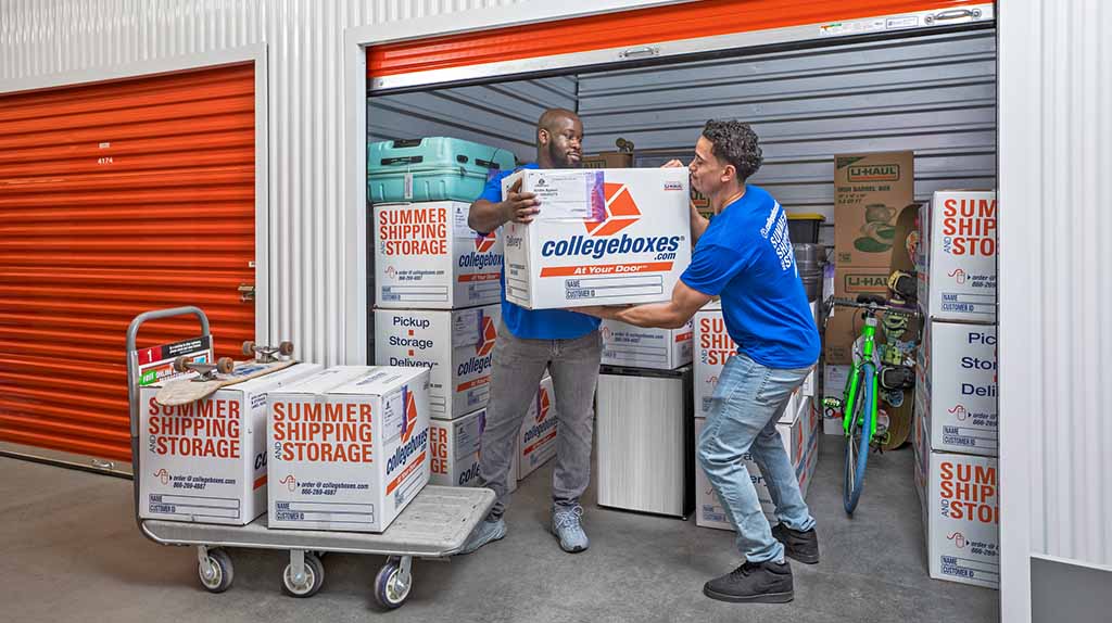 Two Moving Help Service Providers prepare to load a college student’s moving boxes for delivery. Collegeboxes will store your items in a climate-control storage unit.