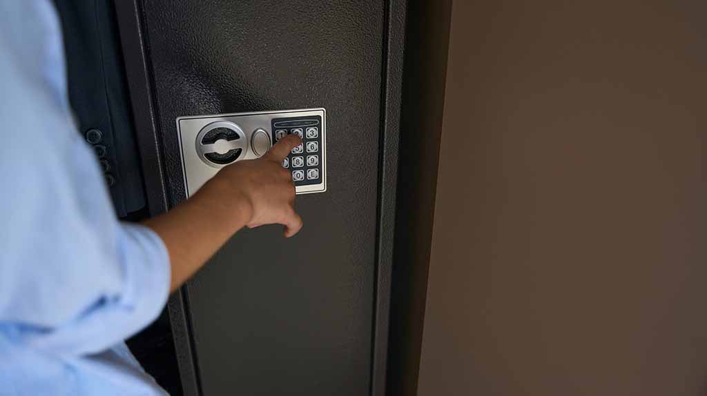 A customer uses the keypad to unlock a gun safe. Moving a gun safe doesn’t have to be difficult when you hire moving labor from Moving Help.