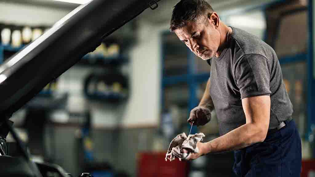 A mechanic completes an oil change and a tune up for a customer’s car.