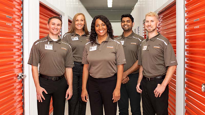 U-Haul employees stand together ready to take care of your military storage needs.