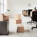 Boxes sit around an office as the employees prepare to pack their office.
