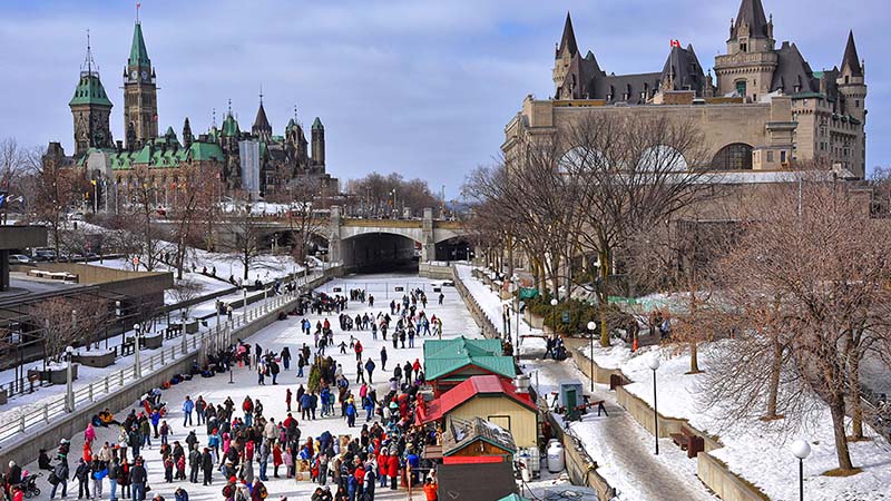 People skate together on the Rideau Canal Skateway in Ottawa. It’s the largest ice rink on Earth, and Ottawa Tourism calls it an unofficial museum.