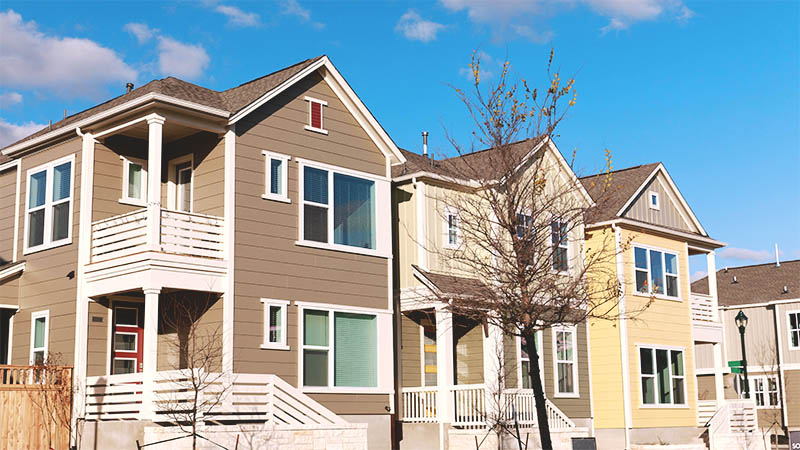 A set of triplex apartments is pictured within a multifamily community complex. Multifamily housing is a good alternative to a more expensive single-family home.