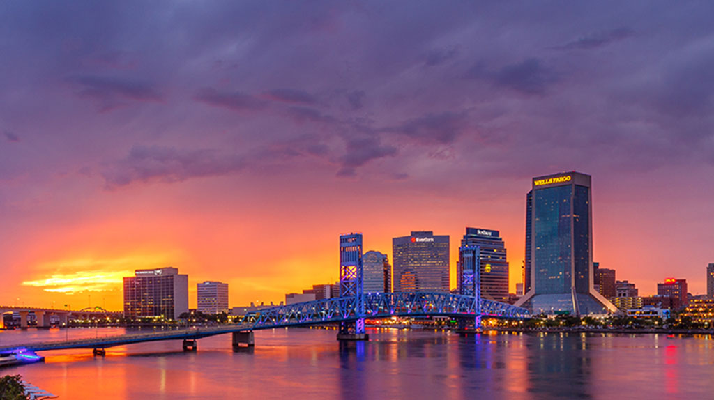 The city of Jacksonville can be seen as the sun begins to set in the background.