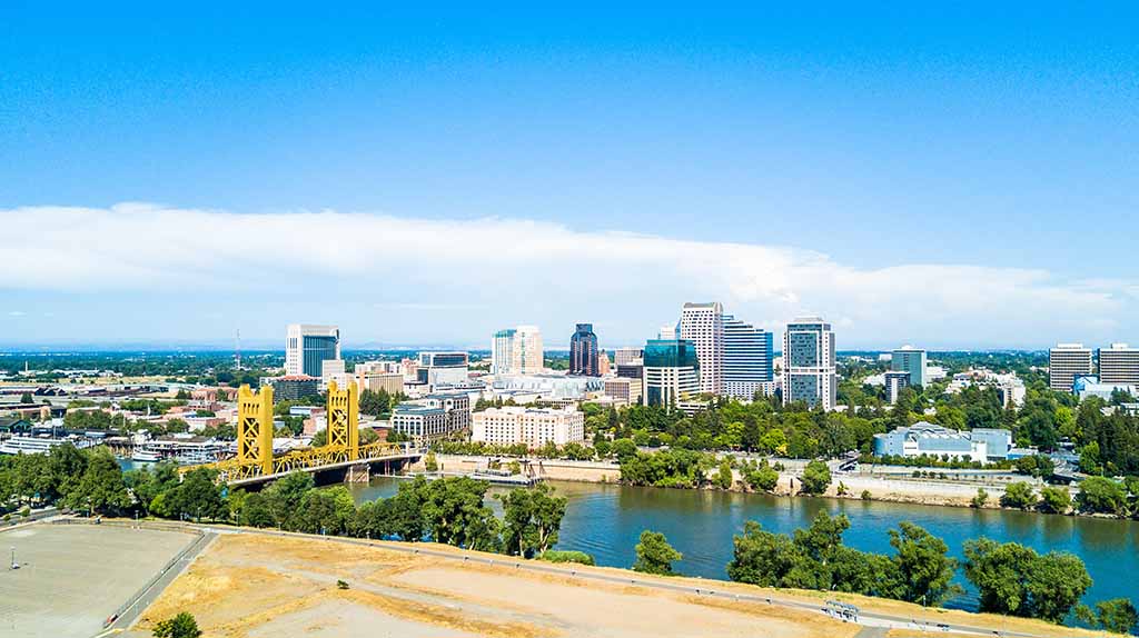 Downtown Sacramento, the Tower Bridge, and the Sacramento River can be seen from the distance.