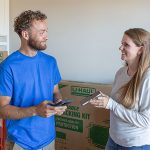 A customer shows the Moving Help Service Provider her Payment Code on her phone after the Moving Helper completed her moving job.