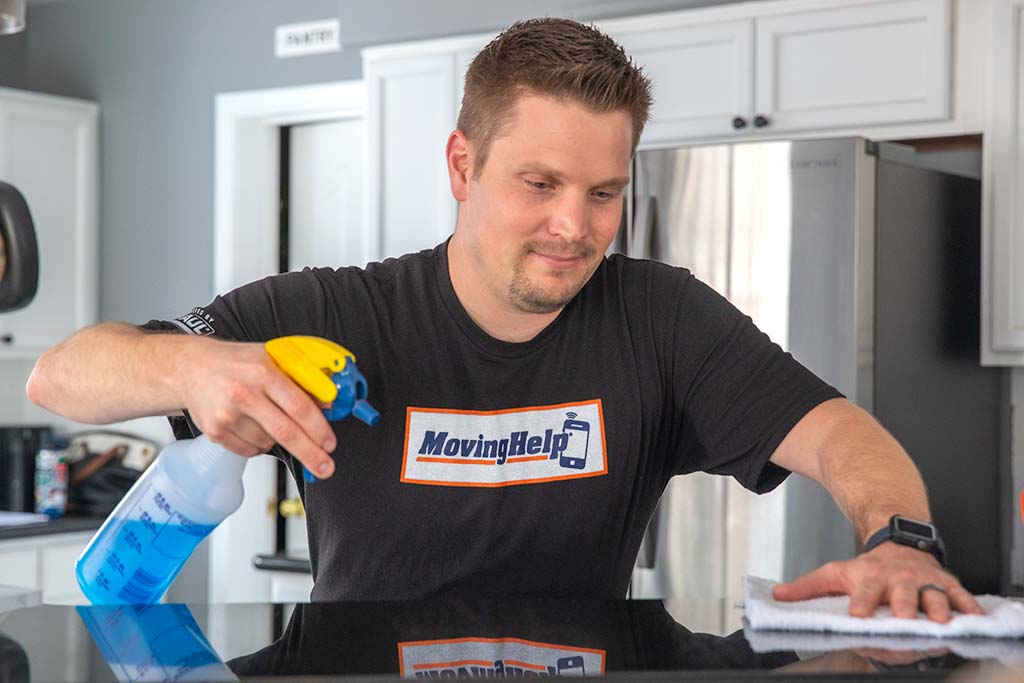 A Moving Helper cleans a kitchen in a customer’s home. A Service Provider can clean your baseboards on moving day as long as the customer provides the cleaning supplies.