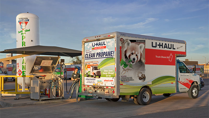 A U-Haul employee fills a U-Haul truck rental with gas. If you don’t refill the gas tank of a U-Haul truck rental, you’ll be charged a fuel charge.