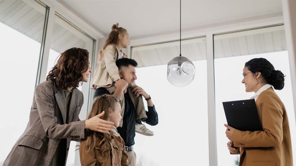 A family of four talks to their female realtor about the house their viewing as first-time homebuyers.