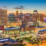 High-rise apartments and high-rise buildings can be seen in an aerial shot on a cool evening in the inner harbor area in Baltimore, Maryland.