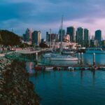 The San Diego skyline can be seen in the evening on a mostly cloudy day.