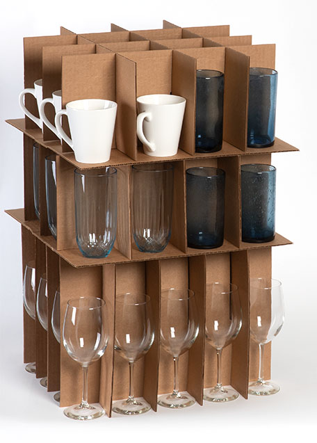 Ceramic cups, Collins glasses, pint glass cups, and wine glasses can be seen stacked together inside a cell kit.