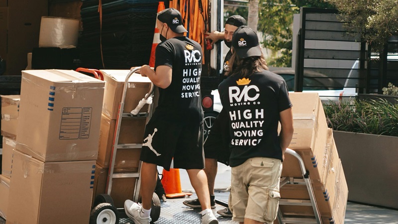 Movers load a moving truck with boxes.