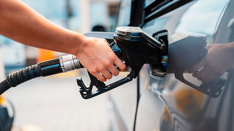 A person begins filling their car’s gas tank with gasoline. Gas prices in 2026 are much higher than expected when experts made their predictions at the beginning of the year.