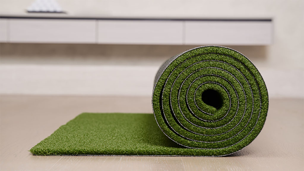 Artificial-turf-1 A roll of artificial turf lies on a countertop.