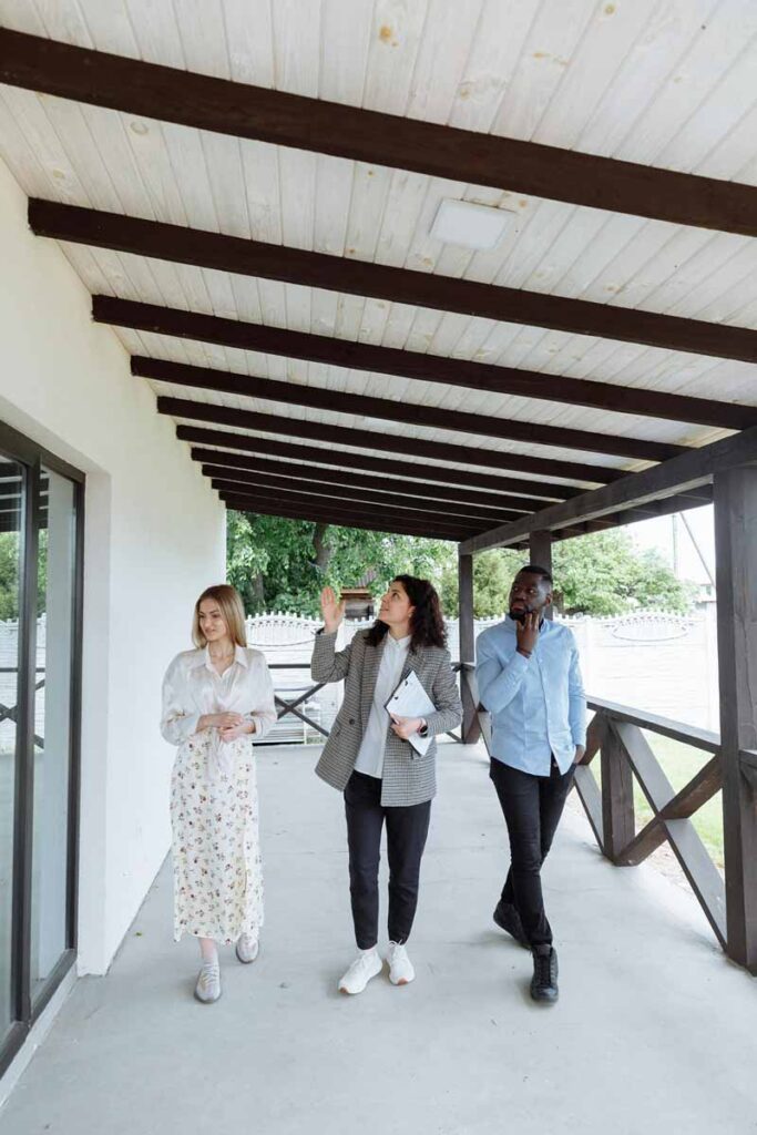 A young couple is touring a home with a real estate agent.